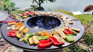 a grill with a bunch of different types of food at Aux Rives de la Courtade in Rivières