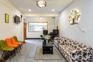 a living room with a couch and a table and chairs at Click Sunburry Hotel Srinagar in Srinagar