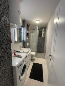 a bathroom with a washing machine and a sink at Amigi in Sarajevo +23 photos