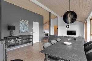 a living room with a table and a couch at Scandinavian villa in South Iceland in Laugaras