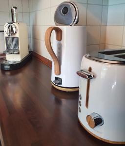 a toaster and coffee maker sitting on a counter at Modernisierte Ferienwohnung Naturseelen mit Schwimmbad und Sauna in Braunlage