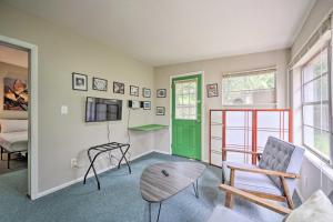 a living room with a green door and a chair at Charming Orlando Duplex about 6 Mi to Downtown! in Orlando