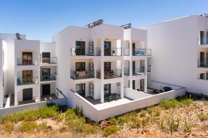 an aerial view of a white apartment building with balconies at Surf & Beach Apartment in Aljezur