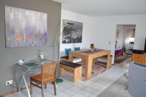 a living room with a table and a dining room at Ferienwohnung Rieth in Dürbheim