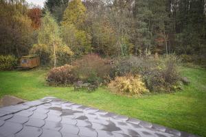 Blick auf einen Garten mit einer Terrasse in der Unterkunft Kleines Bahnhofshotel (Gästezimmer) in Greifenstein