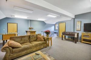 a living room with a couch and a pool table at Premier Condo completely renovated Highridge C8 in Killington