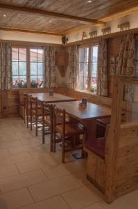 uma sala de jantar com uma grande mesa de madeira e cadeiras em Hotel Eggishorn em Fiesch