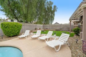 a group of white chairs and a swimming pool at Glendale Gold in Glendale