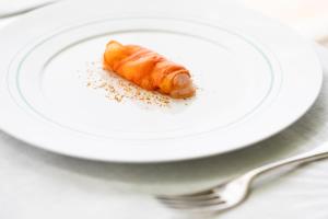a carrot on a white plate with a fork at La Foresteria Planeta Wine Resort & Beach Club in Menfi