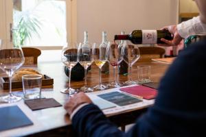 a person pouring a glass of wine on a table at La Foresteria Planeta Wine Resort & Beach Club in Menfi