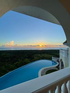 a view of a swimming pool from a balcony at El Castillo Tropical in Cabrera