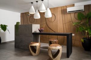 a dining room with a table and two stools at Stella Luxury Apartments in Agia Galini