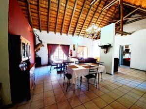 a dining room with a table and chairs at Fish eagle Guest Farm in Phalaborwa