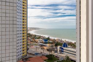 a view of the beach from a building at Suíte Comfort #1004 - em Ponta Negra por Carpediem in Natal