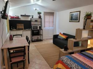 a living room with a couch and a table at Domaine de La Mayonnette in La Crau
