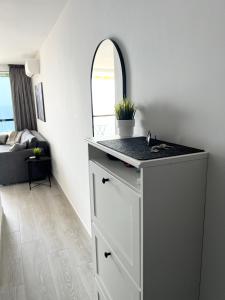 a bathroom with a counter and a sink in a room at Copacabana ocean view apartament in Playa Fañabe