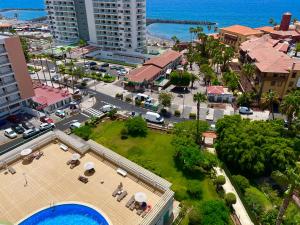 an aerial view of a city with a park at Copacabana ocean view apartament in Playa Fañabe
