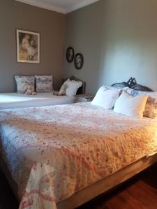 a bedroom with two beds and two clocks on the wall at Adam Inn in Niagara Falls