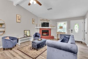 a living room with two blue couches and a fireplace at Pleasant Stay Getaway in Atlanta
