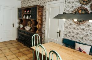 a dining room with a wooden table and chairs at Casa Real 110+2 in Matamorosa