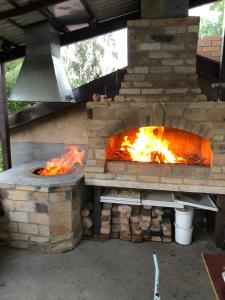 an outdoor pizza oven with fire in it at Rest house Jermuk in Jermuk