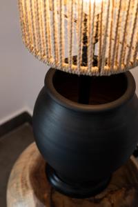 a black lamp sitting on top of a wooden table at Stella Luxury Apartments in Agia Galini