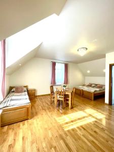 a large room with two beds and a table at Stara Fara in Jurgów