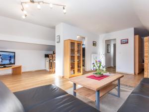 a living room with a table and a couch at Haus Schlossblick in Bad Reichenhall