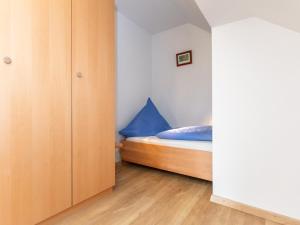 a bedroom with a bed and a closet at Haus Schlossblick in Bad Reichenhall
