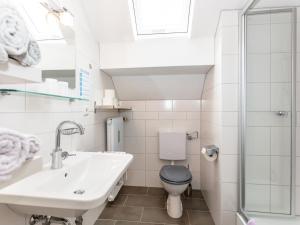 a bathroom with a sink and a toilet at Haus Schlossblick in Bad Reichenhall
