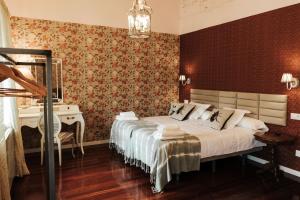 a bedroom with a large bed and a desk at Casa Real 110+2 in Matamorosa