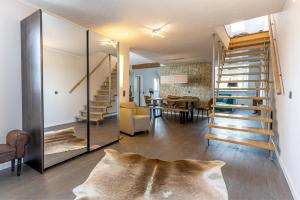 a living room with a staircase and a dining room at Hotel Garni " Am Domplatz" in Erfurt