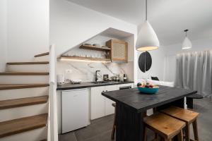 a kitchen with a table with a bowl of fruit on it at Stella Luxury Apartments in Agia Galini