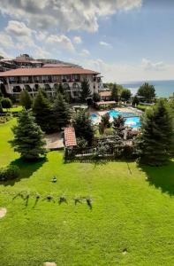 a view of a resort with a green lawn and a pool at Marina Dinevi Complex Monastery 1 Saint Vlas in Sveti Vlas