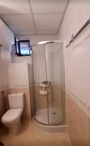 a bathroom with a toilet and a glass shower at Marina Dinevi Complex Monastery 1 Saint Vlas in Sveti Vlas