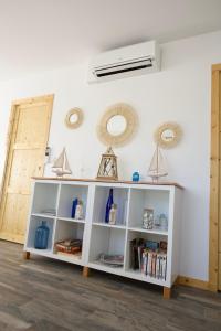 a white book shelf against a white wall at LACADUCEE 