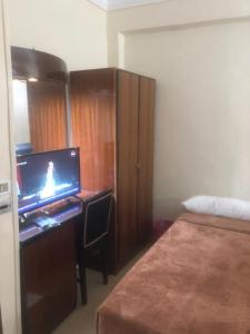 Postel nebo postele na pokoji v ubytování New Saint Catherine Hotel