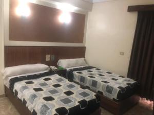 Postel nebo postele na pokoji v ubytování New Saint Catherine Hotel