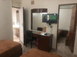 a room with a desk with a television and a mirror at New Saint Catherine Hotel in Luxor