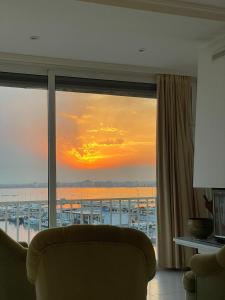 a room with a window with a view of a ship at Luxury family apartment in Roses in Roses