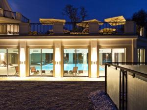 a house with a swimming pool at night at Herbarium Hotel & Spa in Gąsawa
