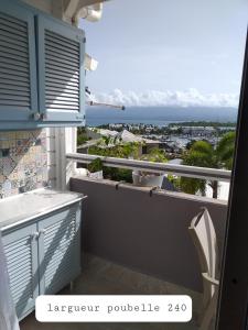 a balcony with a view of the ocean at Blue lagon appart in Le Gosier