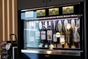 a display of bottles of wine in a machine at Hôtel Saint-Germain Rimouski in Rimouski