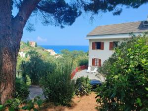 a white house with a view of the ocean at Via dei Ginepri in Noli