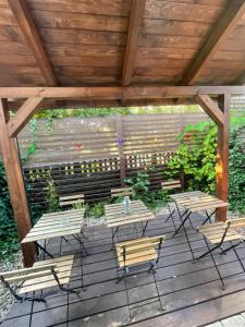 a group of picnic tables and benches on a deck at Casa del Mar free Parking Only Adults for Young U45yrs in Międzyzdroje