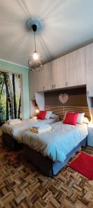 a bedroom with a large bed with red pillows at Le rose di Mapi in Mango