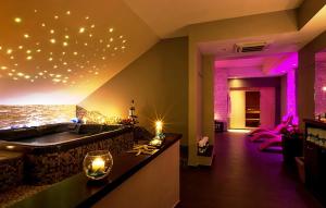 a bathroom with a bath tub with lights on the wall at Amazing Apartment In Foligno With Wifi in Foligno