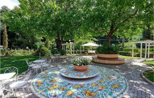 a patio with a table with a flower pattern on it at Amazing Apartment In Foligno With Wifi in Foligno