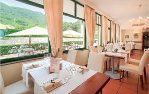 a restaurant with tables and chairs and a large window at Amazing Apartment In Foligno With Wifi in Foligno +14 photos