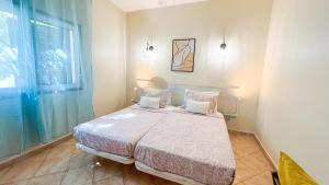 ein Schlafzimmer mit einem Bett und einem Fenster in der Unterkunft Villa Gabriel by Sunny Deluxe in Albufeira + 67 Fotos